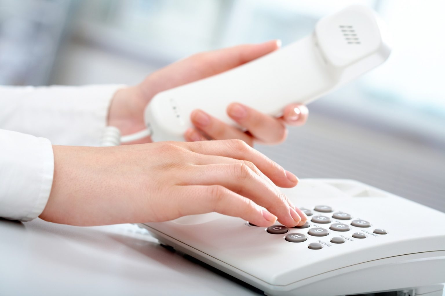 Close-up of receptionist making a phone call