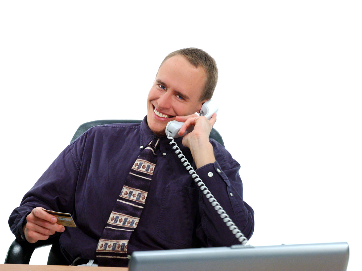 Businessman making a credit card purchase by phone